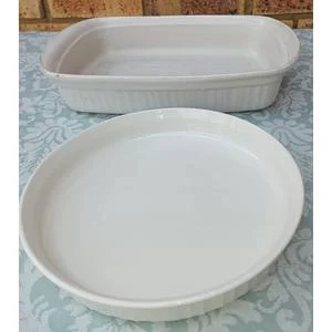Two Corning ware casserole porcelain dishes sold as is