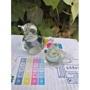 Two paper weights. The smaller one have a small chip